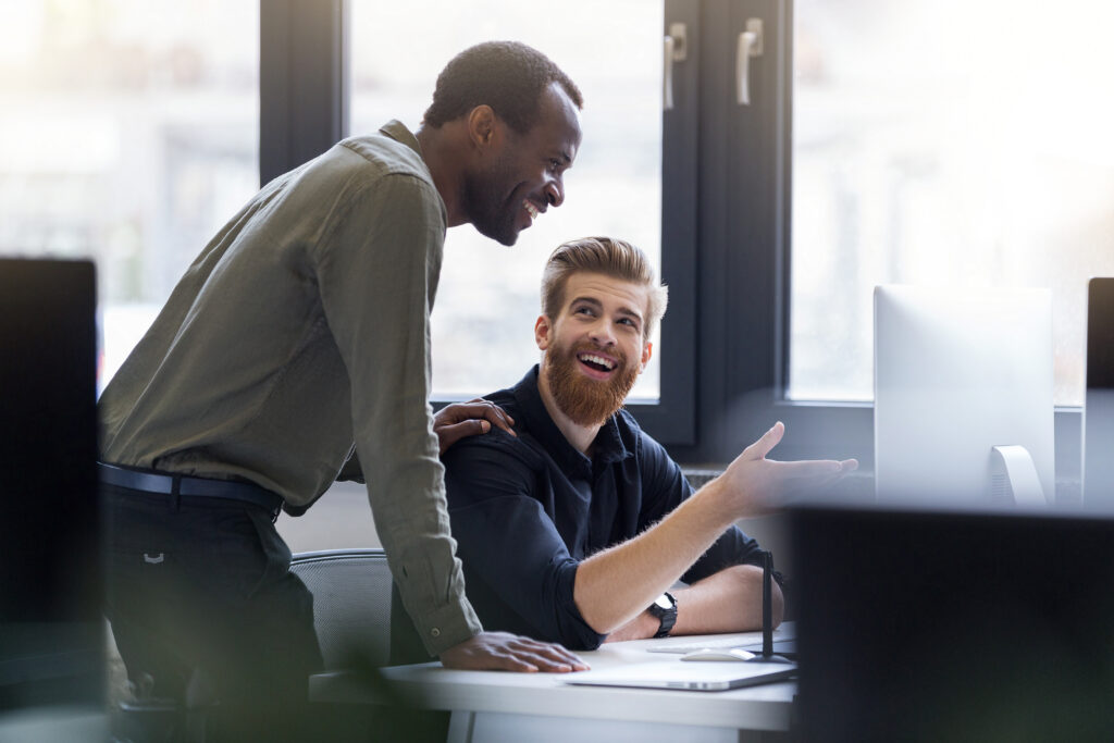 two happy men working together new business project